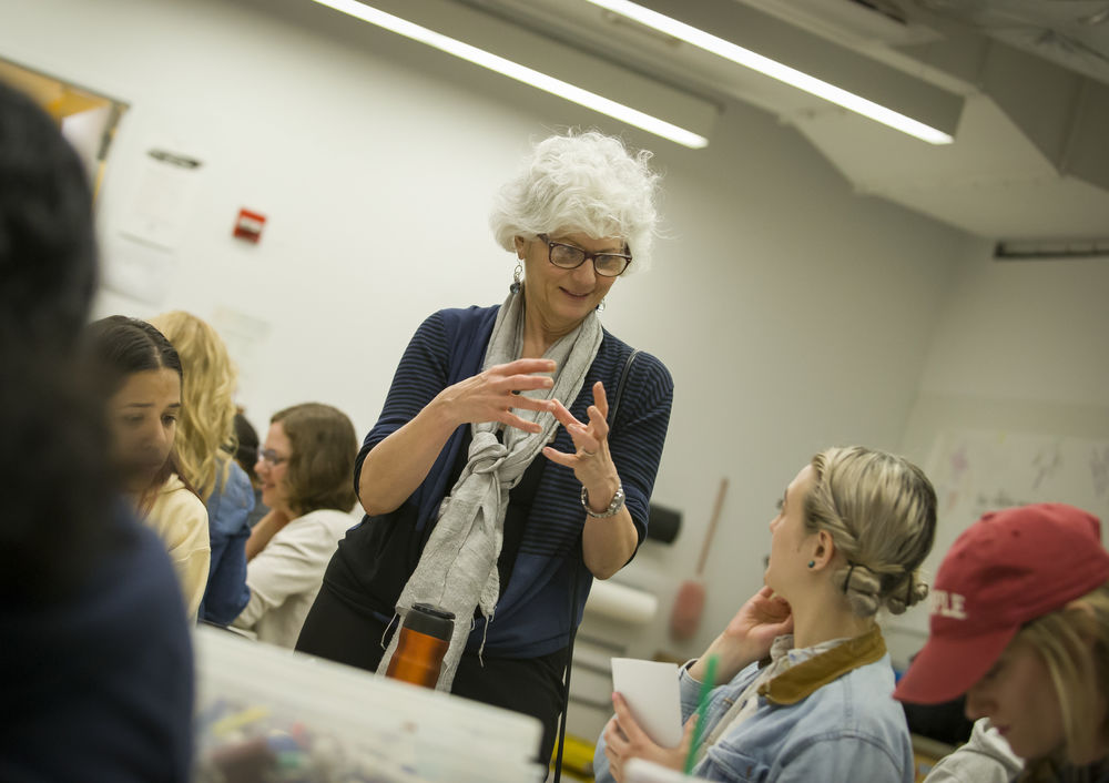 An image of a professor instructing a student in an art therapy class