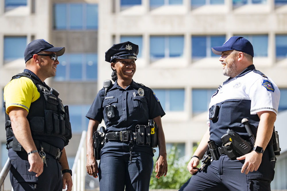 three Temple safety professionals talking.