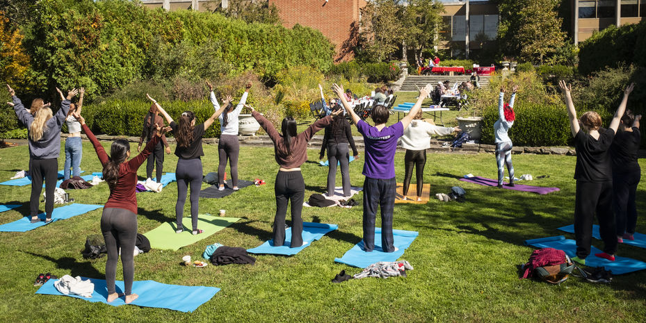 students participating in a group stretching session.